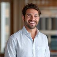 Jsk Guiliotis smiling in a modern office